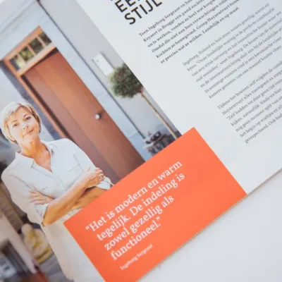 Magazine van Groep Huyzentruyt ligt open op bureau van Bliksem