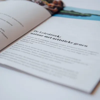 Magazine Leiestreek ligt opengeklapt op bureau van Bliksem Schrijfbureau